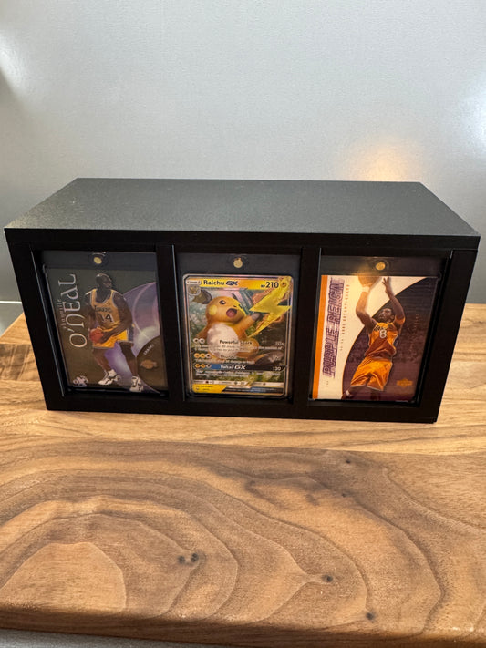 Front display slots of the large One Touch case box with Shaquille O'Neal, Raichu GX and Kobe Bryant cards