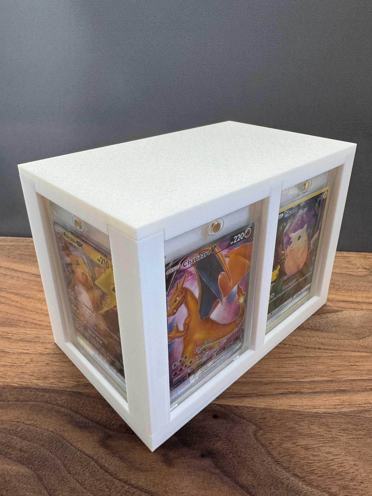 White One Touch Station magnetic case display box with Charizard V and Pikachu Pokemon cards