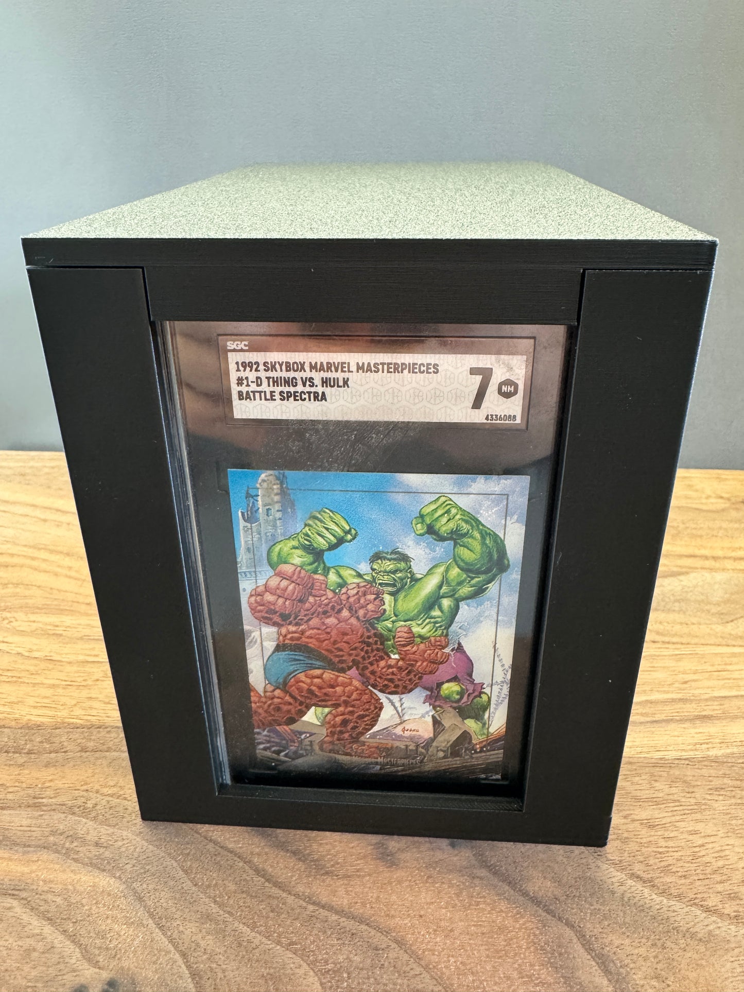 Front view of the SGC Slab Station showing an SGC graded Marvel card