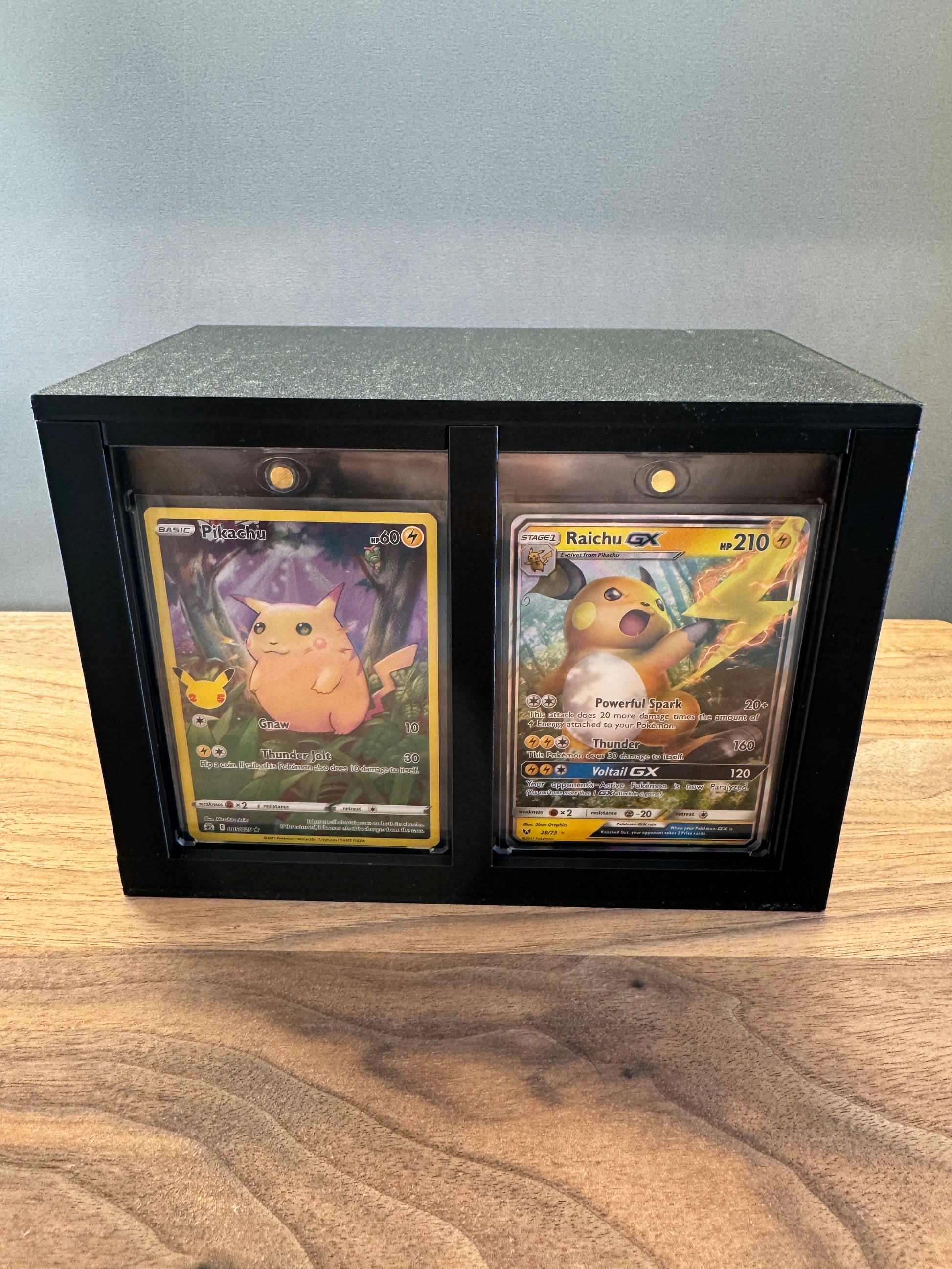 One Touch Station front display slots with Pikachu and Raichu GX Pokemon cards