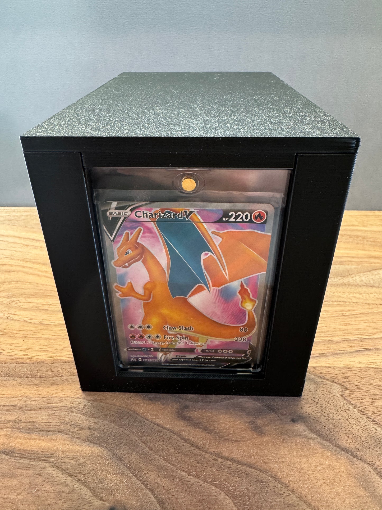 One Touch Station magnetic case display box showing a Charizard V Pokemon card