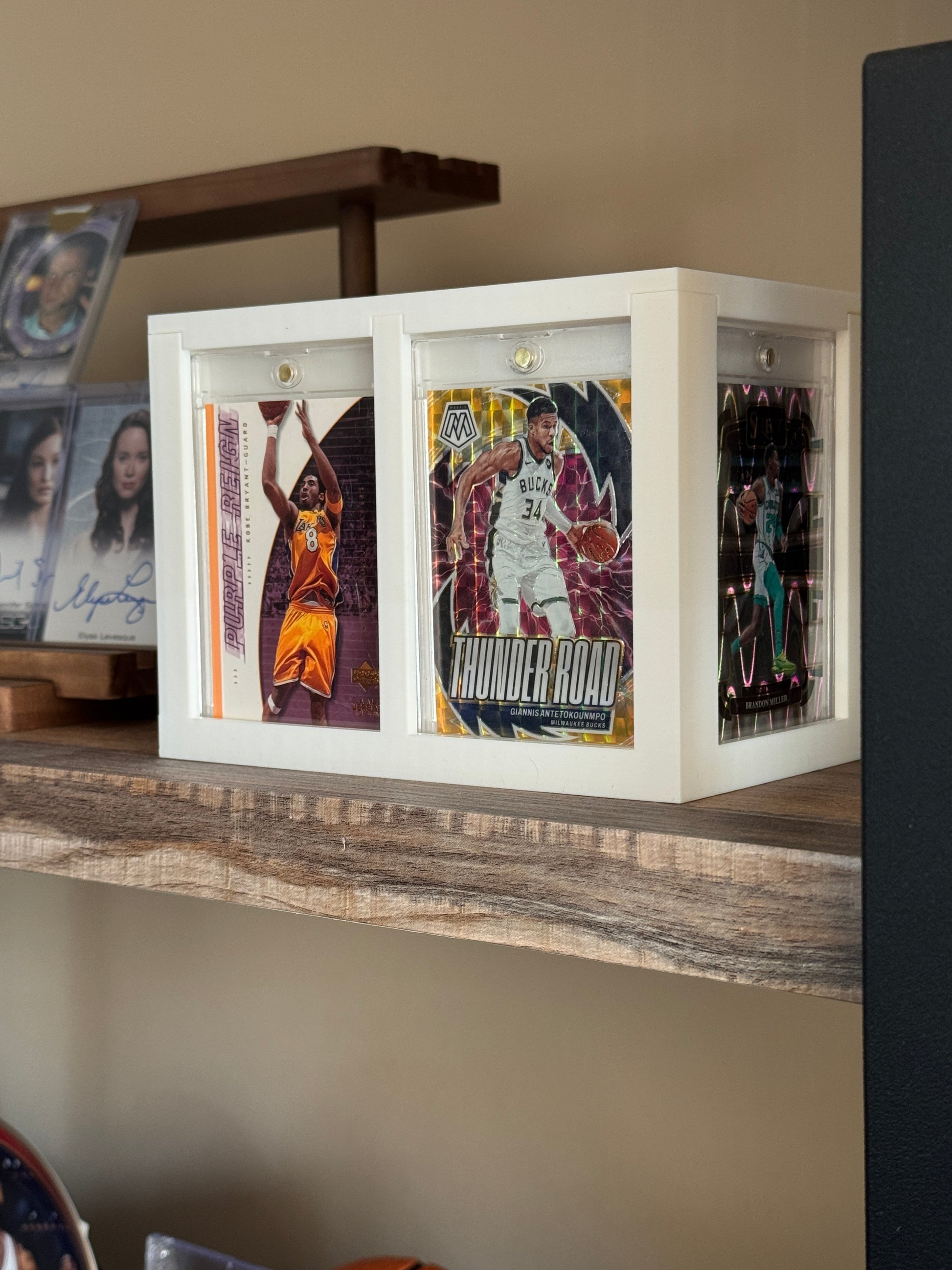 White One Touch Station displaying Kobe Bryant and Giannis basketball cards in magnetic cases