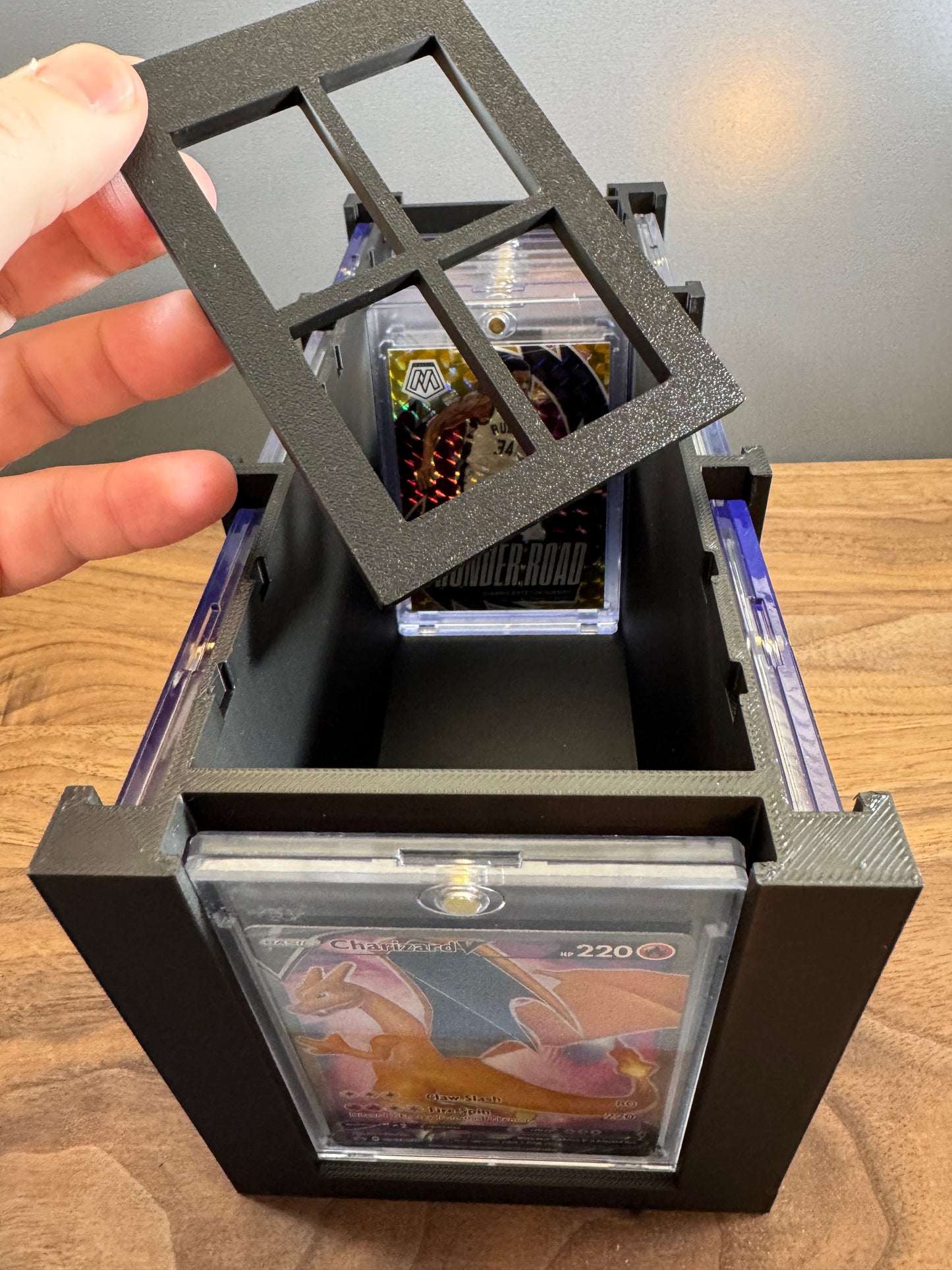 Adjustable divider lifted from the large One Touch card display box with a Giannis basketball card in storage