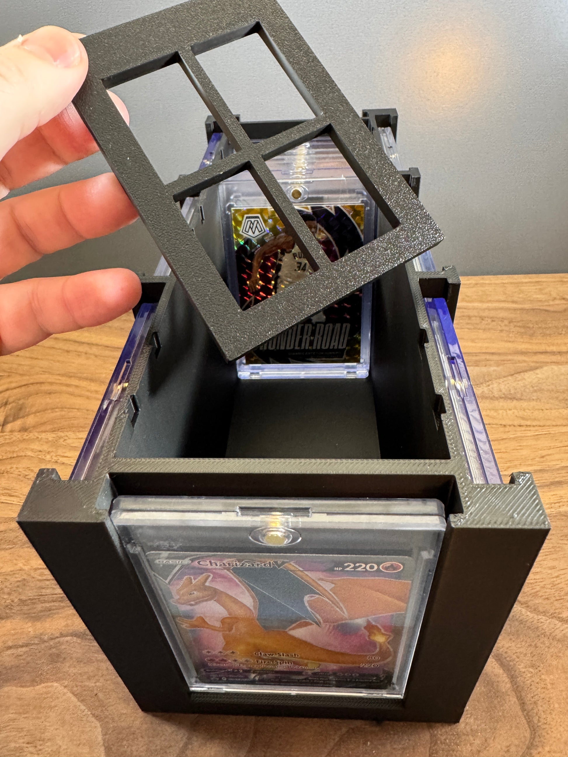 Adjustable divider lifted from the large One Touch card display box with a Giannis basketball card in storage