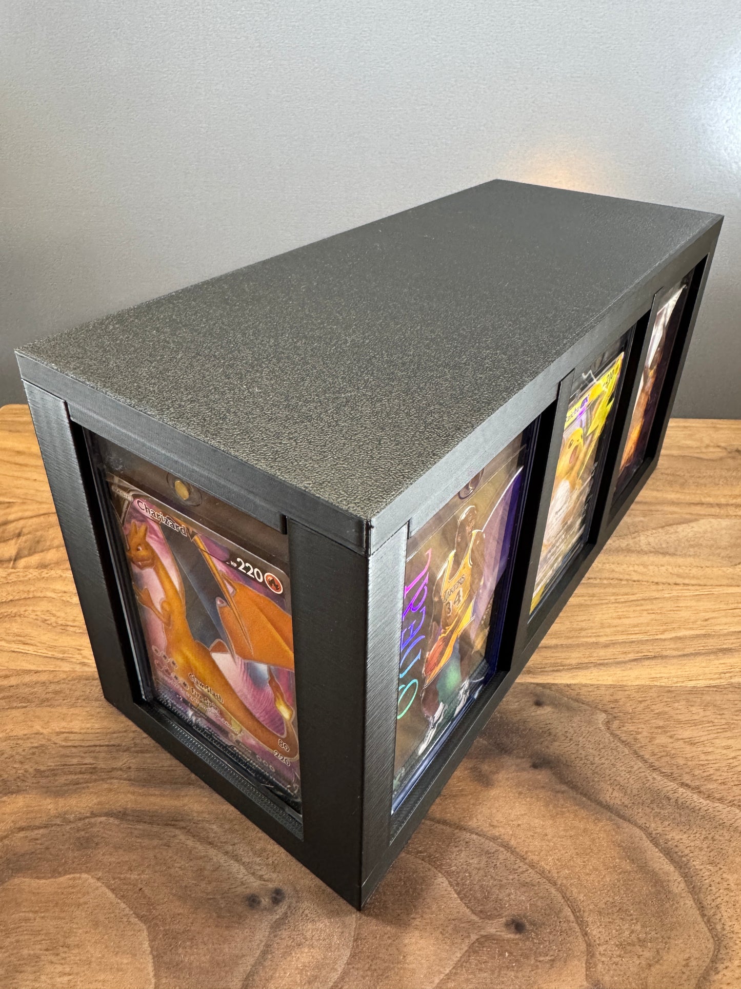 Large One Touch Station with display slots on three sides showing a Charizard V Pokemon card