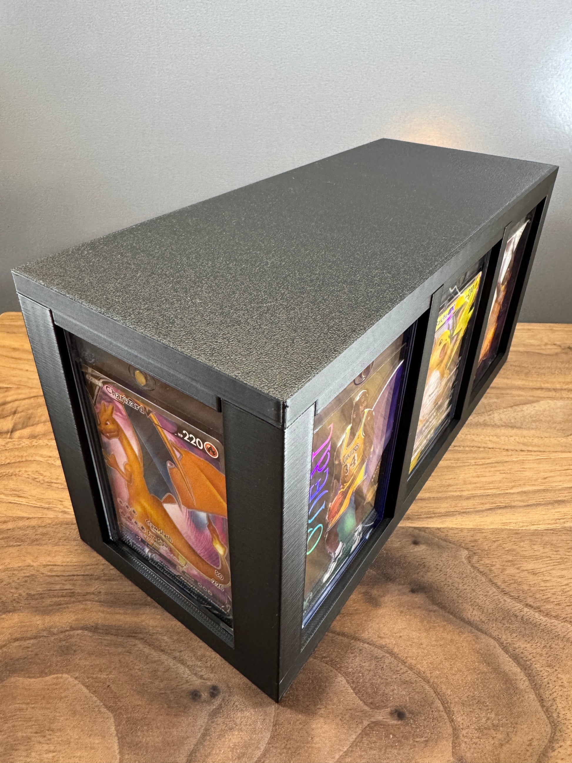 Large One Touch Station with display slots on three sides showing a Charizard V Pokemon card