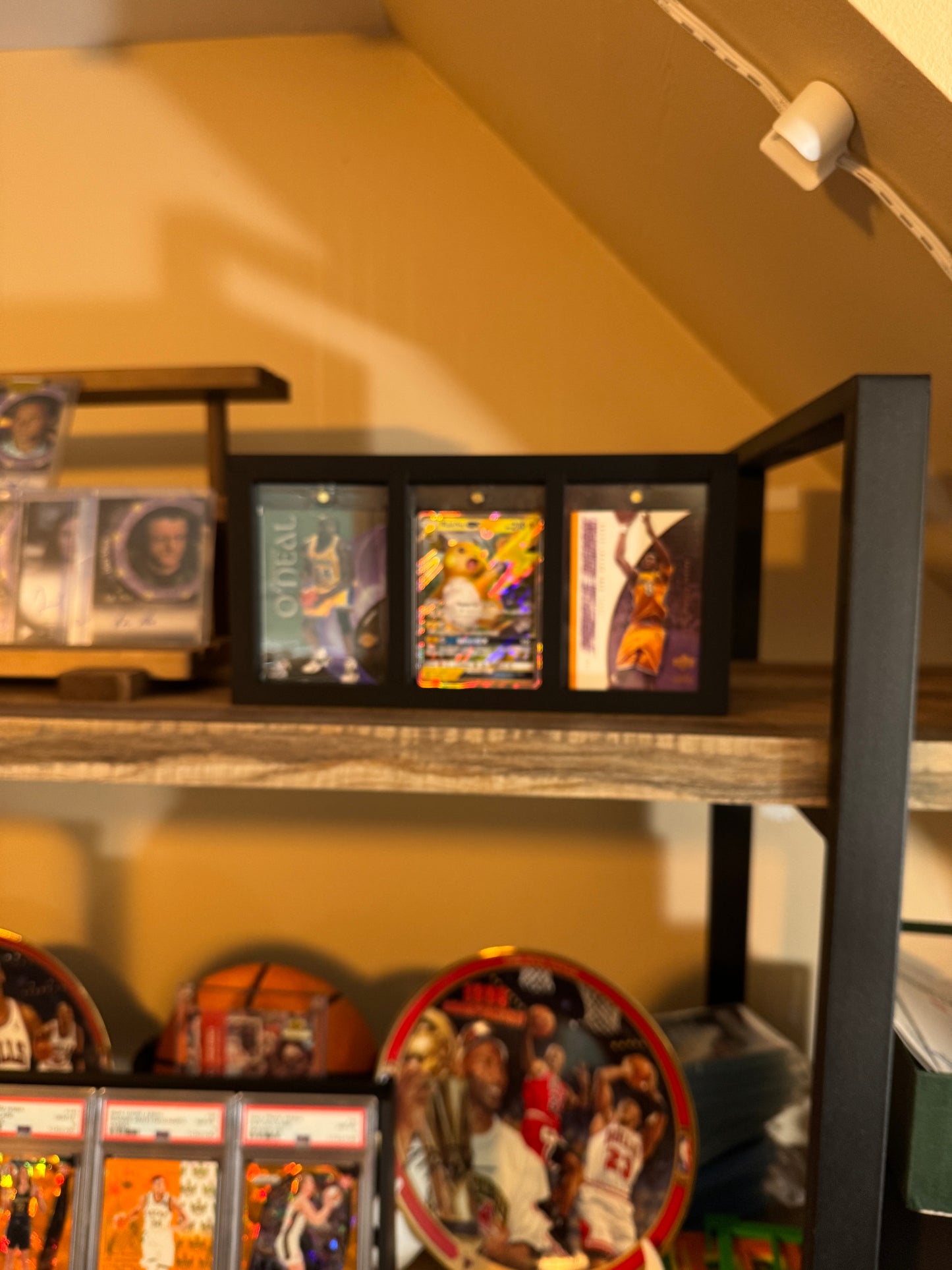 One Touch Station Large on a collector shelf displaying basketball and Pokemon cards