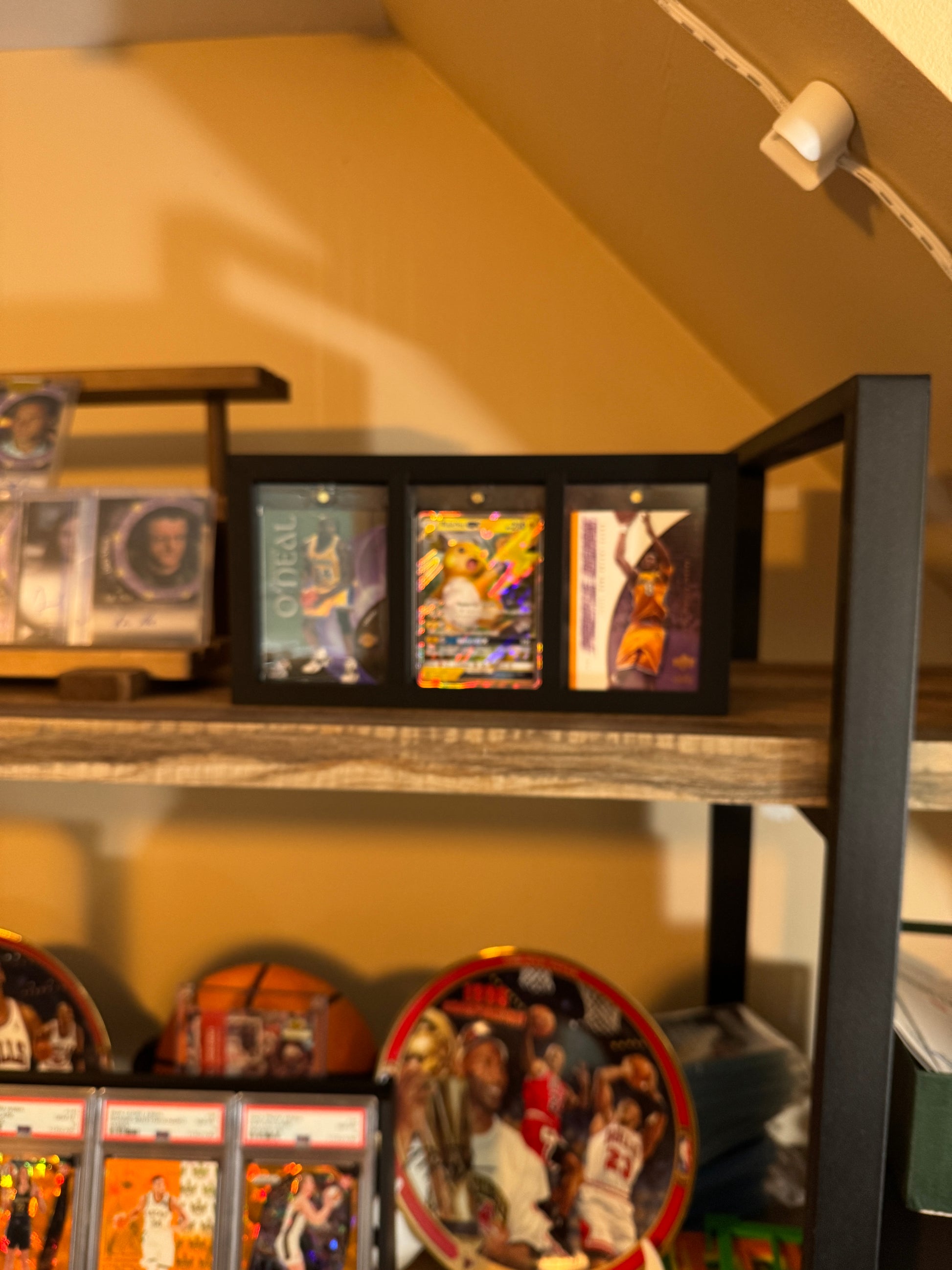 One Touch Station Large on a collector shelf displaying basketball and Pokemon cards