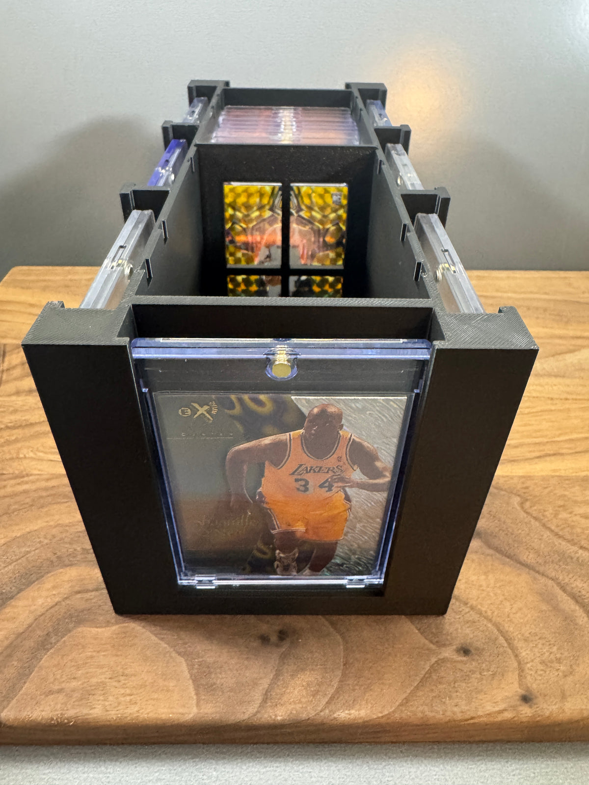 End view of the 180pt One Touch Station with lid off, a basketball card in a thick magnetic case on the front display