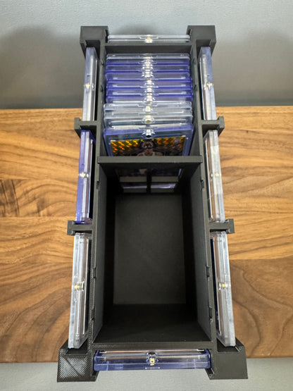 Top view with lid off: 180pt One Touch cases stored inside the black box and 8 thick cases displayed around the outside