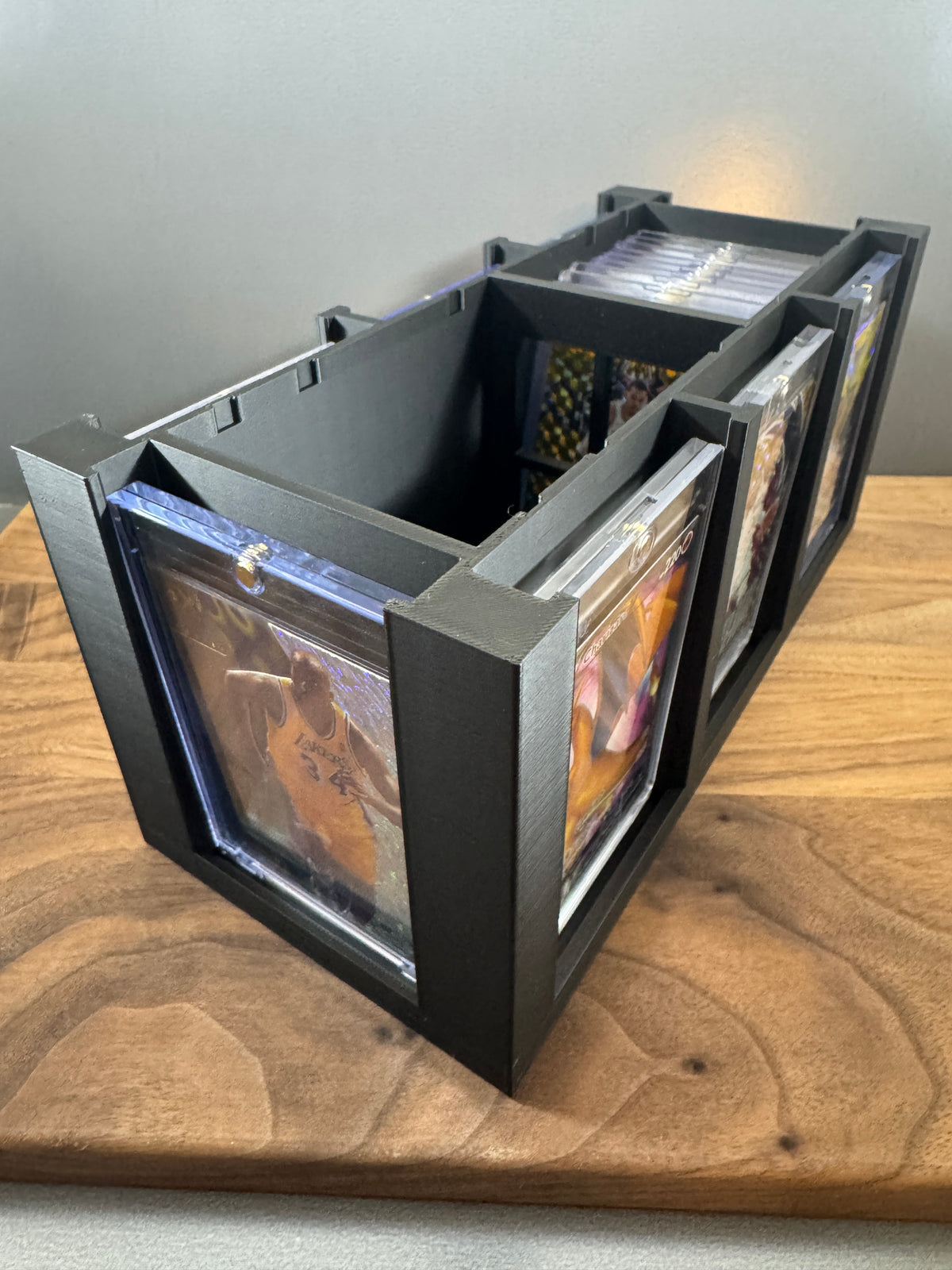 Angled view of the 180pt One Touch storage box with lid removed, showing interior storage and side display slots