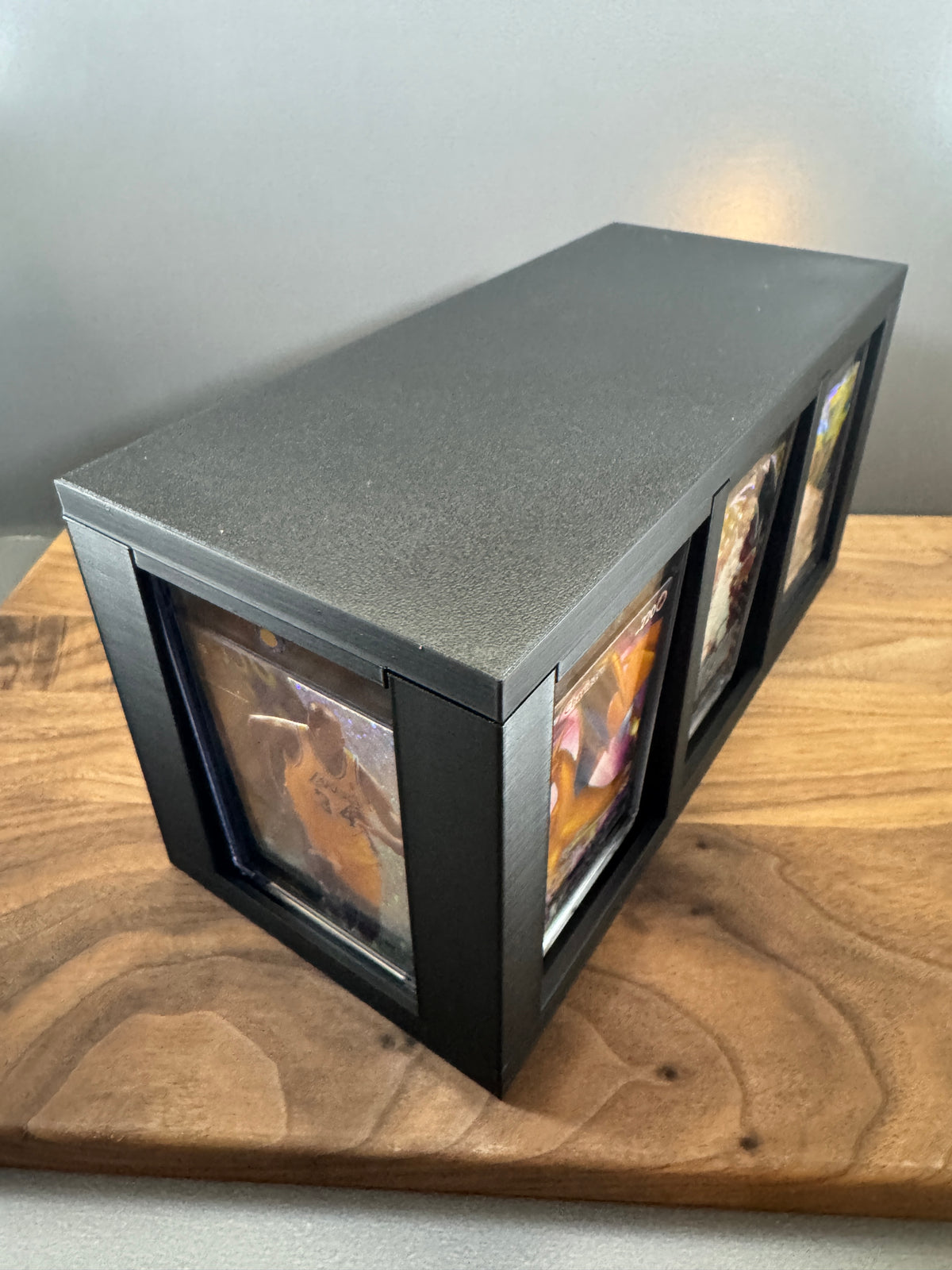 Black 180pt One Touch display and storage box with lid on, thick magnetic card cases showing on the end and side